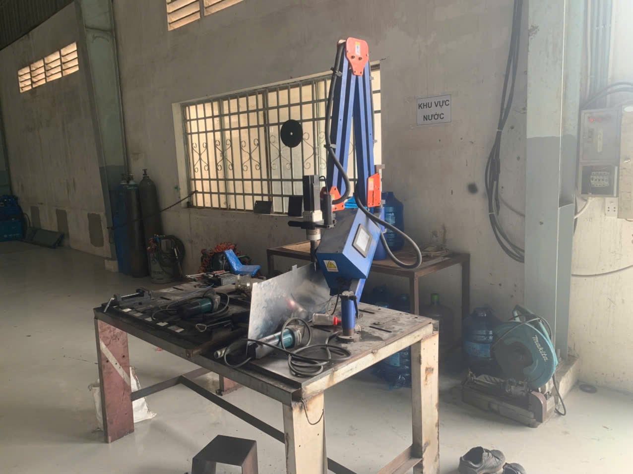 Workbench with electric tapping machine.jpg